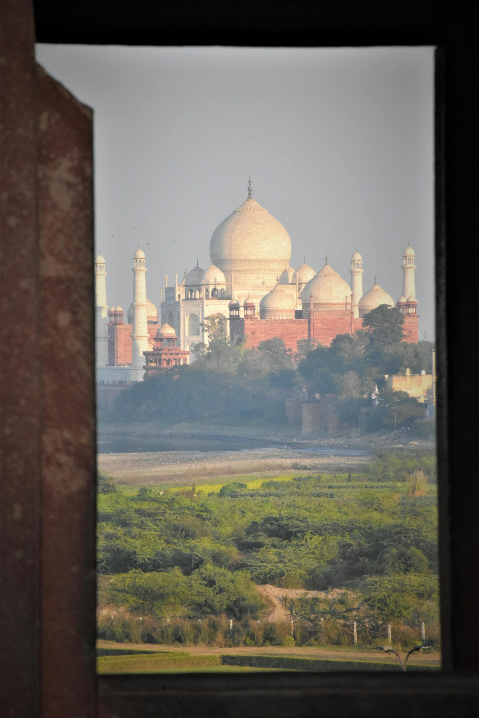 The Taj Mahal in Agra viewed through a stone archway
